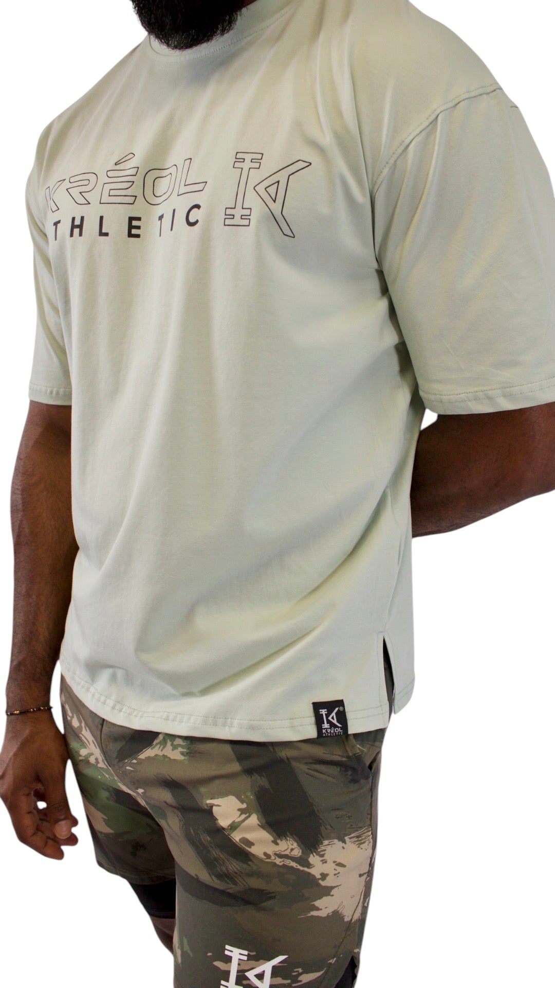 T-shirt oversize vert d'eau KRÉOL ATHLETIC en coton et élasthanne avec logo imprimé sur le devant et message au dos.